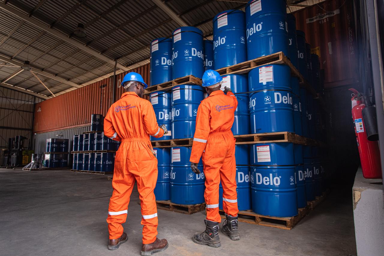 ES&S warehouse team handling supply drums